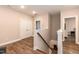 Upstairs landing area with wood floors and view of a bedroom at 9 Moss Side Ter, Durham, NC 27703