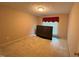 Simple bedroom featuring neutral paint, carpet, and a window for natural light at 100 Deer Ridge Rd, Siler City, NC 27344