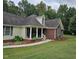 Charming home featuring a well-manicured lawn and beautifully landscaped front yard at 100 Deer Ridge Rd, Siler City, NC 27344