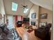 Spacious living room featuring hardwood floors, skylights, and a cozy fireplace at 100 Deer Ridge Rd, Siler City, NC 27344