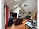 Inviting living room with vaulted ceilings, skylights, and a cozy fireplace at 100 Deer Ridge Rd, Siler City, NC 27344