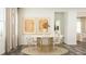 Bright dining room with a round wooden table, six chairs, and modern art prints at 1032 Red Finch Way, Angier, NC 27501