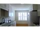 Bright eat-in kitchen with white cabinetry and stainless steel appliances at 106 Knight Ct, Graham, NC 27253