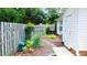 Landscaped side yard featuring mature plants, mulch ground cover, and a wood privacy fence at 106 Knight Ct, Graham, NC 27253