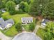 Overhead view of the home featuring mature trees and a well-manicured lawn at 107 Winter Ct, Selma, NC 27576