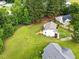 Home aerial showcasing backyard, neighborhood, and surrounding landscape at 107 Winter Ct, Selma, NC 27576