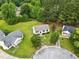 An aerial shot of a cozy home nestled in a neighborhood with mature trees and manicured lawns at 107 Winter Ct, Selma, NC 27576