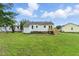Cozy home featuring a well-maintained backyard and a charming wooden deck at 107 Winter Ct, Selma, NC 27576