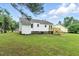This home has a nice backyard with a small wooden deck and an extra outside storage area at 107 Winter Ct, Selma, NC 27576