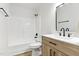 Bathroom featuring a bright shower, natural wood vanity with sleek black hardware, and modern mirror at 107 Winter Ct, Selma, NC 27576