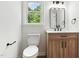 Modern bathroom featuring a vanity, toilet, and bright natural light from a window at 107 Winter Ct, Selma, NC 27576