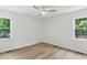 Bright bedroom featuring neutral walls, modern ceiling fan, and natural light from two windows at 107 Winter Ct, Selma, NC 27576