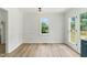 Bright dining area with white walls, wood-look floors, and natural light, creating an inviting eating space at 107 Winter Ct, Selma, NC 27576