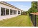 Expansive backyard with a black fence, well-maintained lawn, and a seamless transition from indoor to outdoor living at 1104 Gaston Manor Dr, Durham, NC 27703