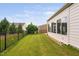 Side yard with a green lawn and fencing, offering a private outdoor space perfect for relaxation and entertainment at 1104 Gaston Manor Dr, Durham, NC 27703