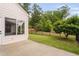 A well-manicured backyard featuring a black fence, green grass, and a patio area, perfect for outdoor enjoyment at 1104 Gaston Manor Dr, Durham, NC 27703