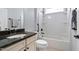 Well-lit bathroom featuring a shower-tub combo and a vanity with a granite countertop at 1104 Gaston Manor Dr, Durham, NC 27703
