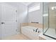 This bathroom boasts a tub with a tile surround and a large glass-enclosed shower at 1104 Gaston Manor Dr, Durham, NC 27703