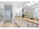 Bright bathroom features a double vanity with granite counters and separate tub and shower with glass enclosure at 1104 Gaston Manor Dr, Durham, NC 27703