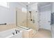 Bathroom featuring a glass enclosed shower, soaking tub and tile surround at 1104 Gaston Manor Dr, Durham, NC 27703