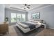 Stylishly furnished bedroom with large windows, carpeted floors, tray ceilings, and neutral tones at 1104 Gaston Manor Dr, Durham, NC 27703