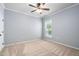 Bedroom featuring neutral carpet, a ceiling fan, and a window offering natural light at 1104 Gaston Manor Dr, Durham, NC 27703