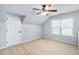 Attic bedroom featuring a ceiling fan, neutral walls, carpet and a window at 1104 Gaston Manor Dr, Durham, NC 27703