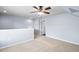 Carpeted bonus room featuring neutral paint, a ceiling fan and a doorway for easy access at 1104 Gaston Manor Dr, Durham, NC 27703
