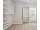 Bright walk-in closet featuring custom shelving for optimal storage at 1104 Gaston Manor Dr, Durham, NC 27703