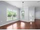 Bright dining room with large windows and hardwood floors at 1104 Gaston Manor Dr, Durham, NC 27703