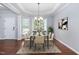 Bright dining room boasts a modern chandelier, large windows, and elegant decor at 1104 Gaston Manor Dr, Durham, NC 27703