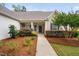 Charming covered entrance with lush landscaping, leading to the front door at 1104 Gaston Manor Dr, Durham, NC 27703