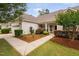 Inviting walkway leading to the front door surrounded by lush landscaping and mulch at 1104 Gaston Manor Dr, Durham, NC 27703