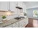 Close-up of the kitchen with granite countertops, white cabinetry and stainless steel appliances at 1104 Gaston Manor Dr, Durham, NC 27703