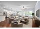 Open-concept living room showcases modern decor, ceiling fan, and access to the kitchen at 1104 Gaston Manor Dr, Durham, NC 27703