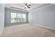 Bright main bedroom with carpeted floors and large windows at 1104 Gaston Manor Dr, Durham, NC 27703