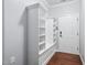 This mudroom features a useful storage cubby with hooks, cabinets and drawers by the entry door at 1104 Gaston Manor Dr, Durham, NC 27703