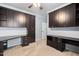Office space featuring built-in cabinetry, dual workstations, and a ceiling fan at 1104 Gaston Manor Dr, Durham, NC 27703