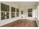 Bright sunroom with hardwood floors and many windows offering views of the backyard at 1104 Gaston Manor Dr, Durham, NC 27703