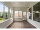 Bright sunroom with hardwood floors and many windows offering views of the backyard at 1104 Gaston Manor Dr, Durham, NC 27703