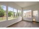 Bright sunroom with hardwood floors and many windows offering views of the backyard at 1104 Gaston Manor Dr, Durham, NC 27703
