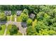 Aerial perspective of a home and neighborhood, surrounded by mature trees at 113 Fox Run, Henderson, NC 27536
