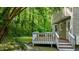 Backyard deck, greenery, and the home's siding at 113 Fox Run, Henderson, NC 27536