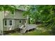 Backyard featuring a wood deck, greenery, and the home's siding at 113 Fox Run, Henderson, NC 27536