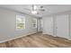 Bedroom featuring ceiling fan, wood-look floors, and bright windows at 113 Fox Run, Henderson, NC 27536