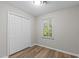 Bedroom featuring wood-look flooring and a spacious closet at 113 Fox Run, Henderson, NC 27536