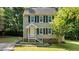 Charming two-story home featuring a landscaped front yard and welcoming front entrance at 113 Fox Run, Henderson, NC 27536