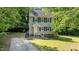 Inviting two-story home featuring a classic design with black shutters and landscaped front yard at 113 Fox Run, Henderson, NC 27536