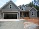 Charming two-story home features gray siding, attached garage, and inviting front porch details at 1155 Shonele Ln, Stem, NC 27581