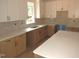 Light and bright kitchen with shaker cabinets, stone countertops, and stainless steel appliances at 1155 Shonele Ln, Stem, NC 27581